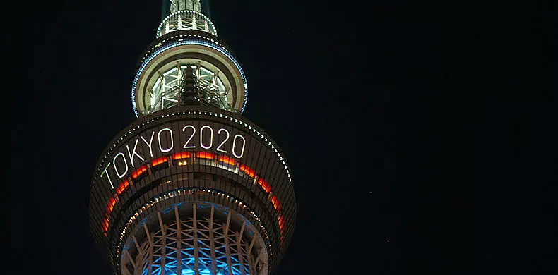 Tokyo Skytree tower illuminated at night, displaying the words 