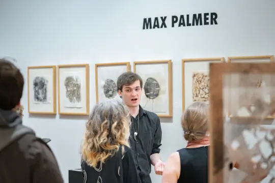 An Arts Administration student presenting at an art show