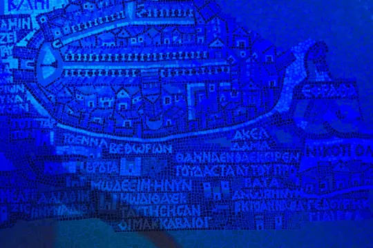 A blue mosaic illustrating an ancient city map, interweaving Jewish history with various structures and streets. The design features buildings, roads, and inscriptions in Greek, all rendered in a detailed and textured style evoking antiquity through the lens of Israel Studies.