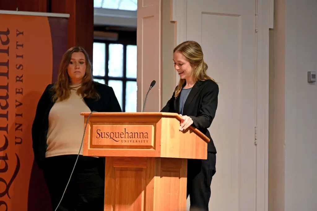 Two women at a podium with