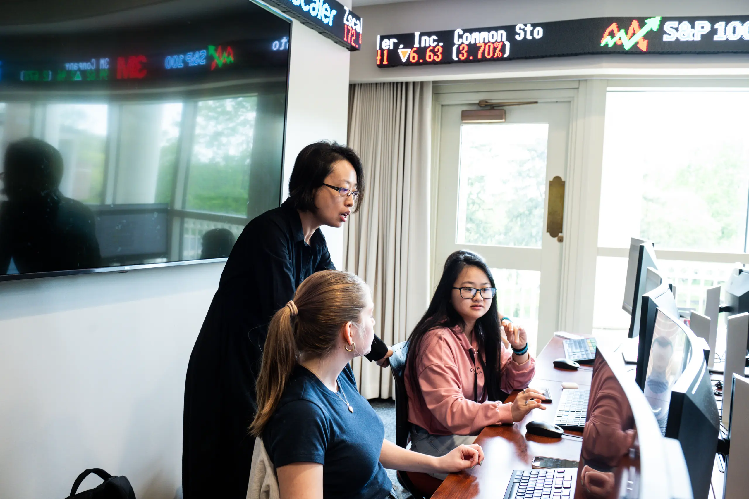 A Sigmund Weis School of Business professor advising students in class 