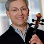 A man holding a violin.