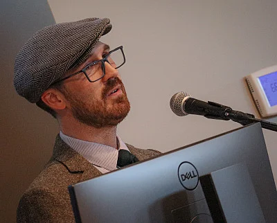 Patrick Thomas Henry '08 speaks at the SU Press launch party.