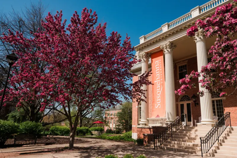A historic brick building with tall columns and a 
