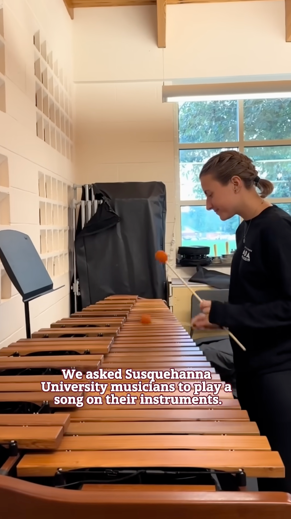 A person from the School of the Arts plays a xylophone with two mallets in a room. Text on the image reads, 