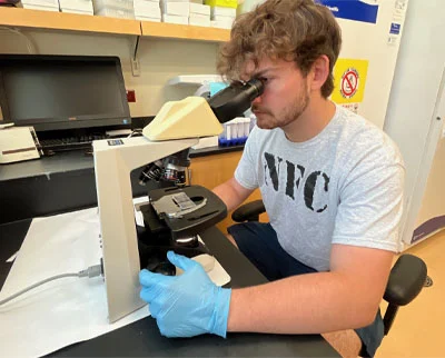 A man wearing a gray 